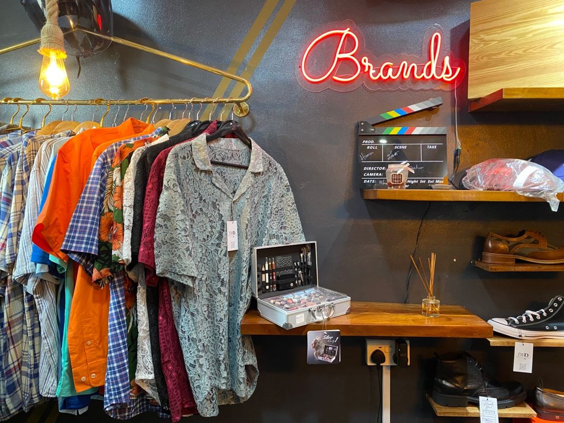 Shirts and shoes on display inside the DHP Fashion store